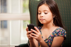 Little girl watching movie on phone.